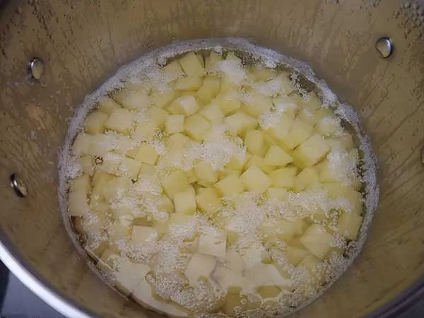 Cooked potatoes in pot.