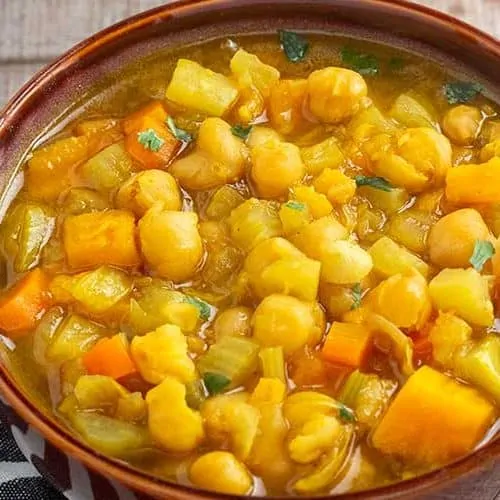 Instant Pot chickpea stew in brown bowl.