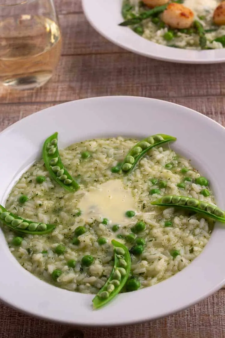 Instant Pot Pea and Mint Risotto in white bowls with glass of wine.