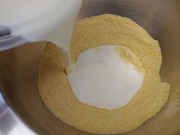 Pouring buttermilk mixture into cornmeal.