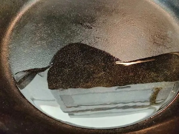 Heating oil in cast iron skillet.