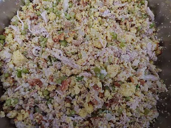 Cornbread and stuffing mixed with turkey and vegetables.