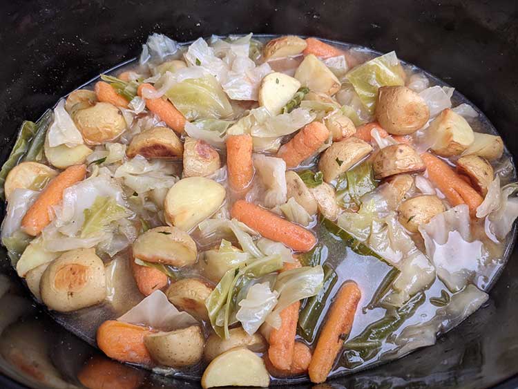 Cabbage, potatoes, and carrots in slow cooker.