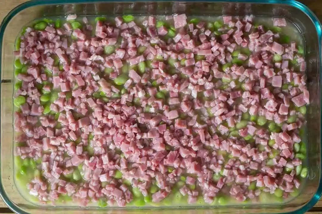diced ham and baby lima beans with chicken broth in Pyrex dish