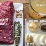 ingredients for pressure cooker corned beef on white plates with a wood background