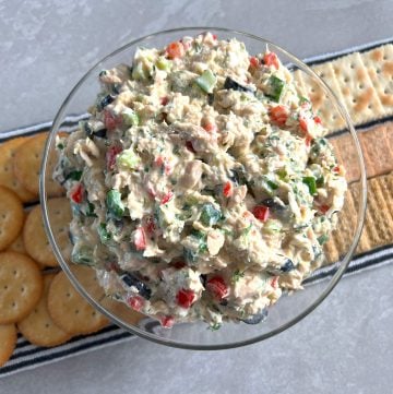 Bowl of Mediterranean tuna salad with different crackers behind.
