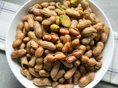 Boiled peanuts in a white bowl.