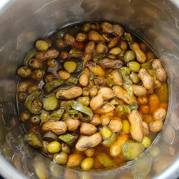 Cooked boiled peanuts with pickles, jalapenos, and olives in Instant Pot.