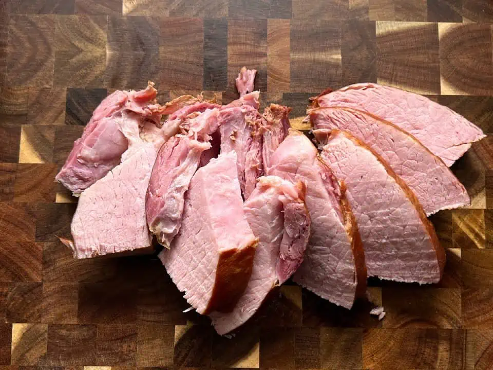 Sliced ham in a cutting board.