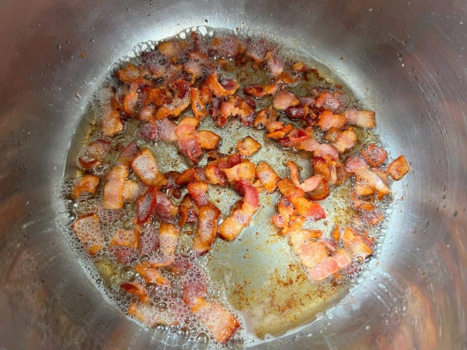 Crispy bacon pieces in bottom of an Instant Pot.