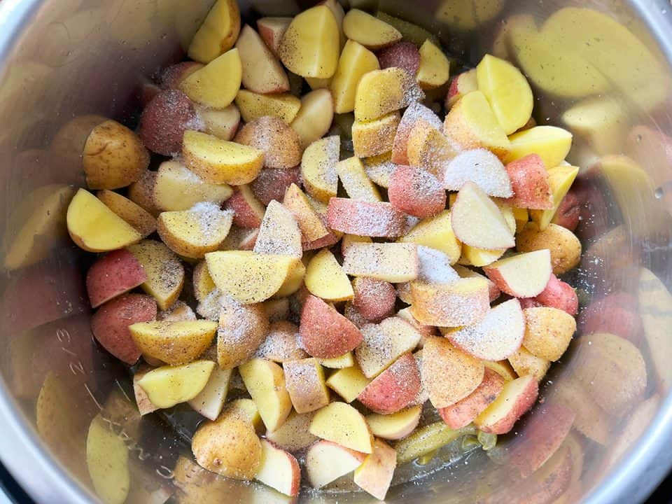 Chopped potatoes topped with salt and pepper in an Instant Pot.