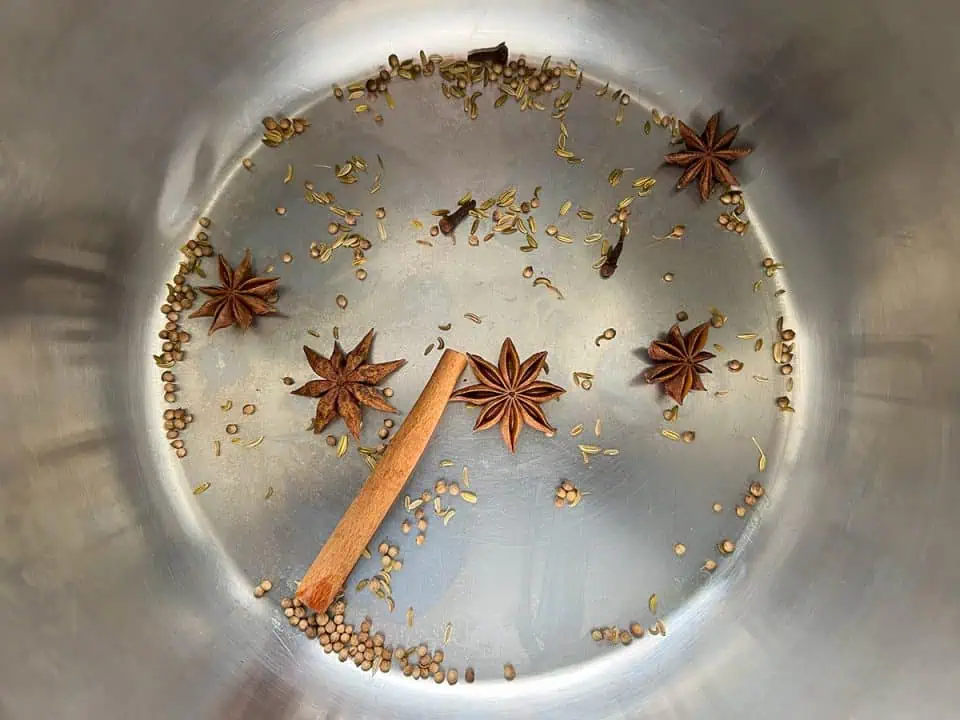 Spices toasting in bottom of an Instant Pot.