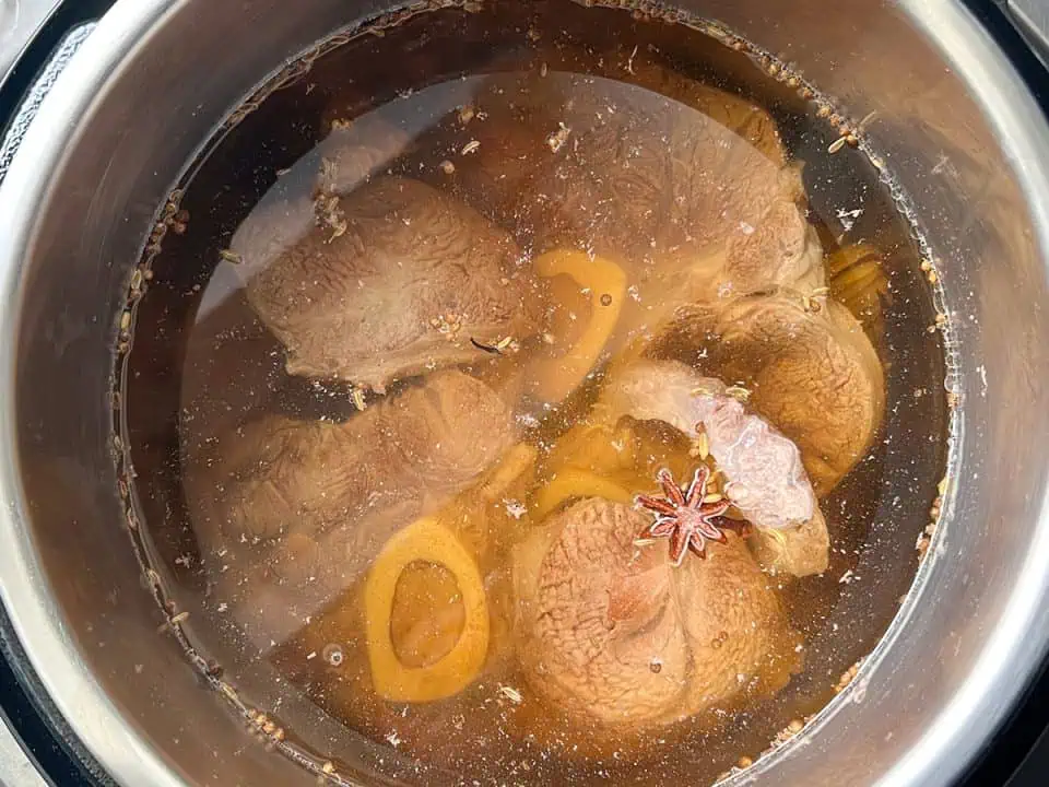 Beef shanks in water with spices.