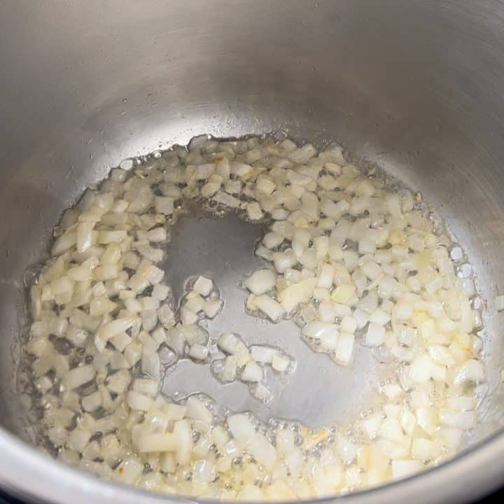 Diced onions cooking in an Instant Pot.