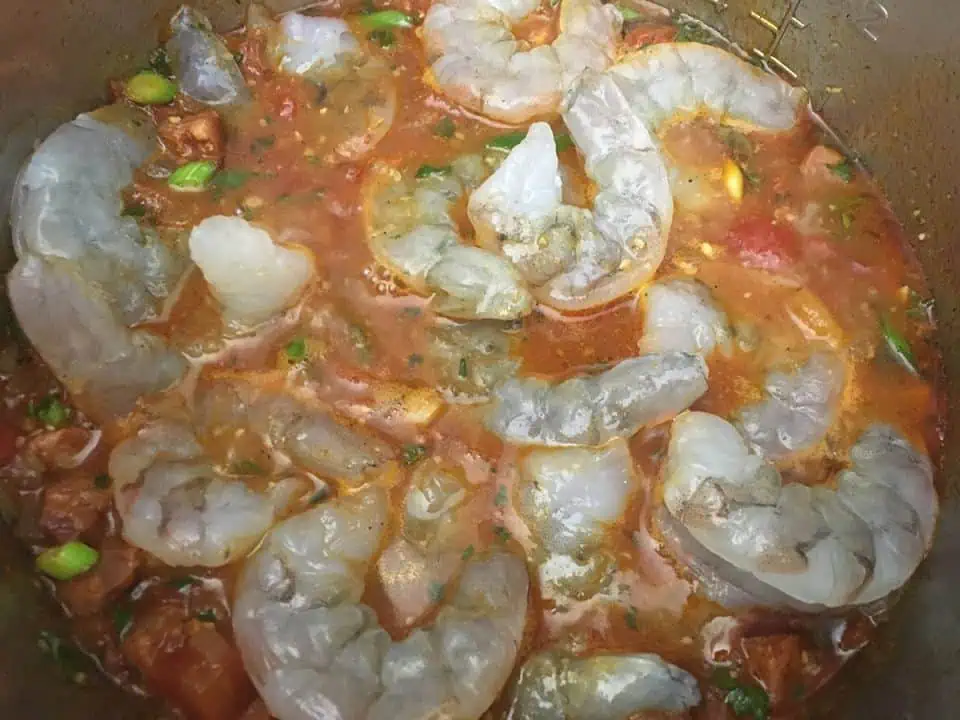 Uncooked shrimp in red sauce.