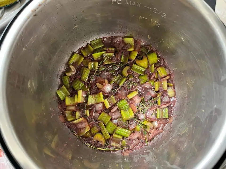 Aromatics and red wine reducing in an Instant Pot.