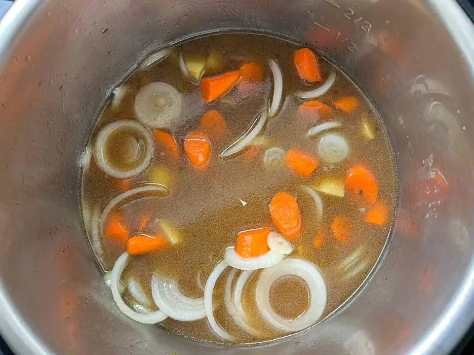 Potatoes, onions, and carrots in beef broth.