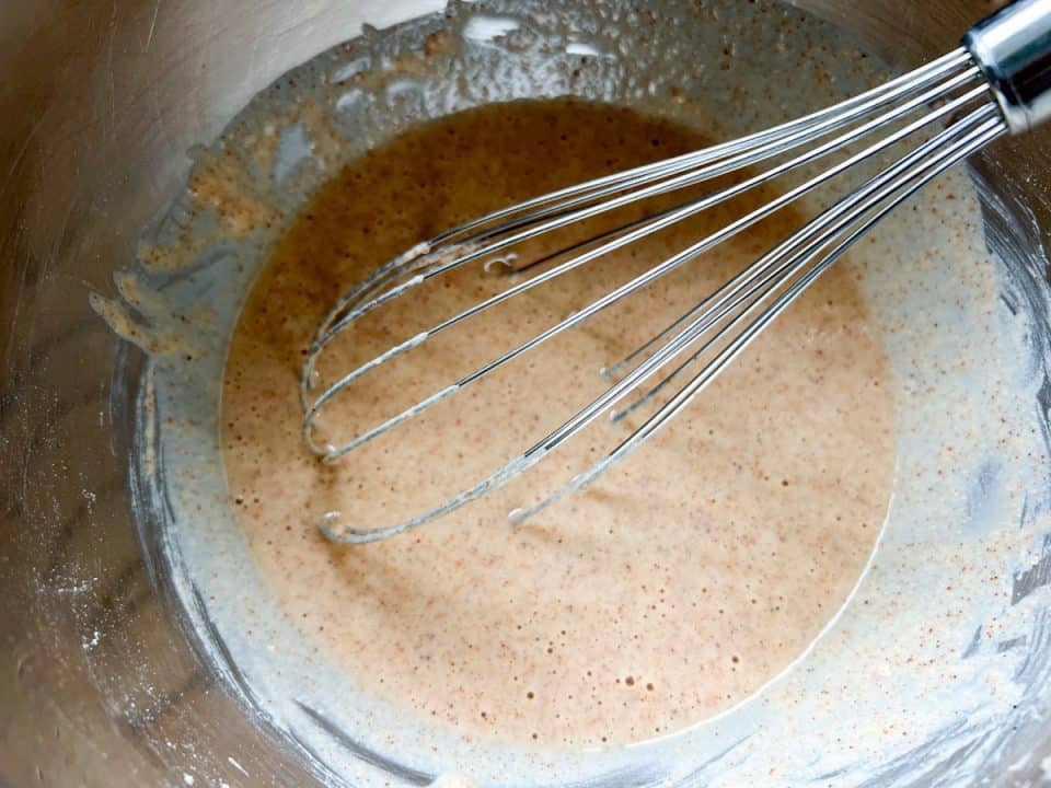 Batter in mixing bowl with whisk.