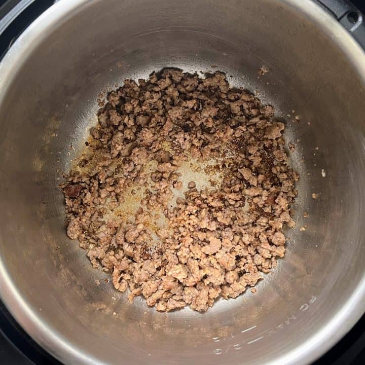 Ground sausage browning in an Instant Pot.