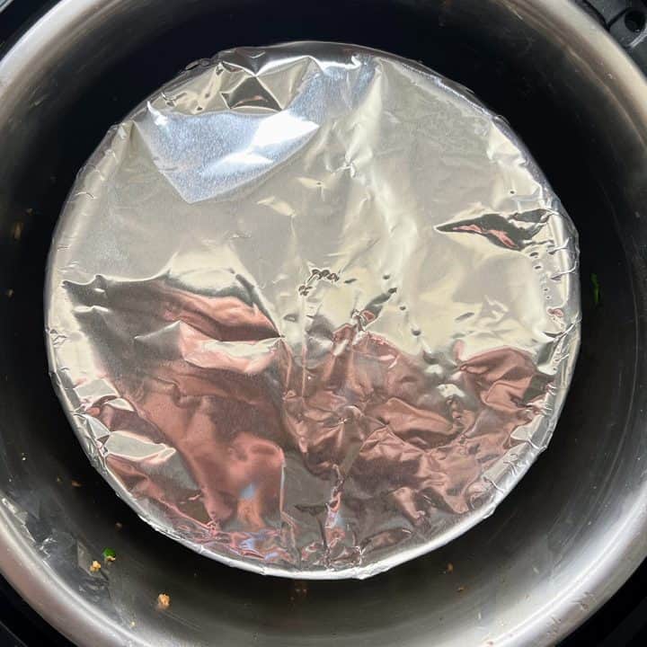 7-inch pan covered with aluminum foil sitting inside an Instant Pot.