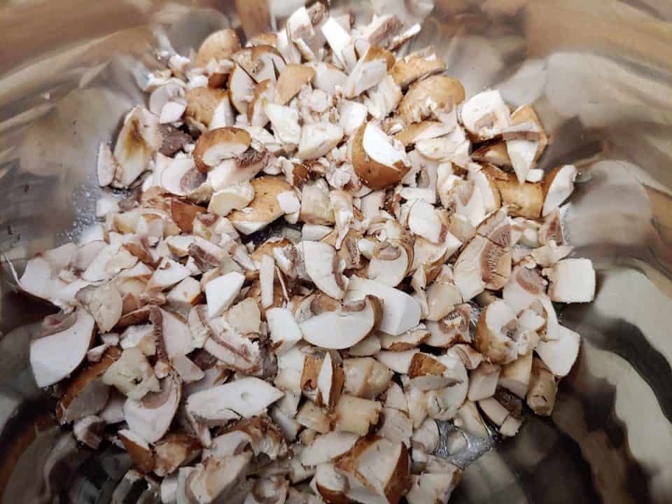 Finely chopped mushrooms in pot.
