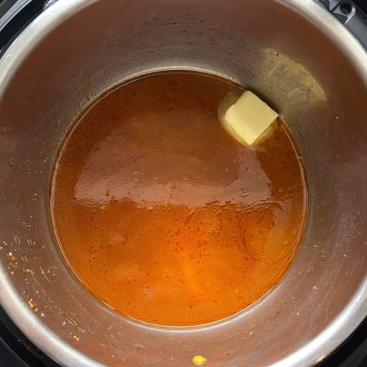 Broth and pat of butter in bottom of pot.