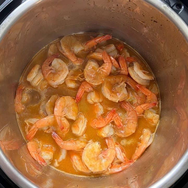Cooked shrimp and butter in broth in bottom of pot.