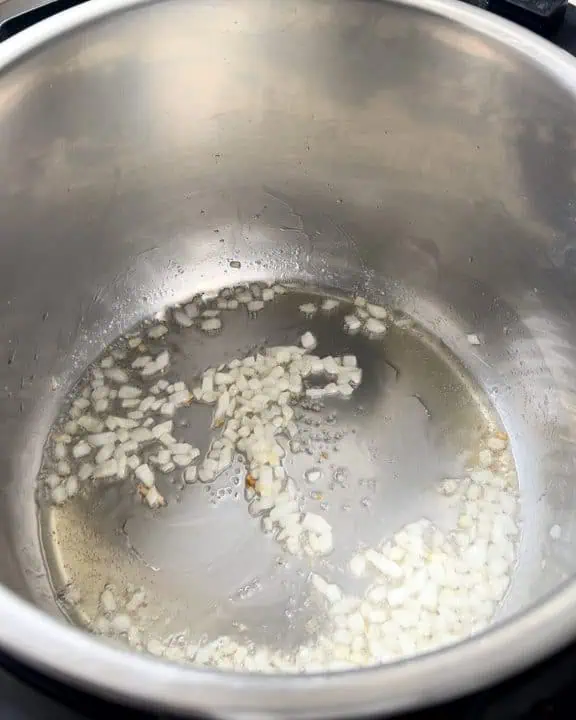 Sauteing diced onions in Instant Pot.