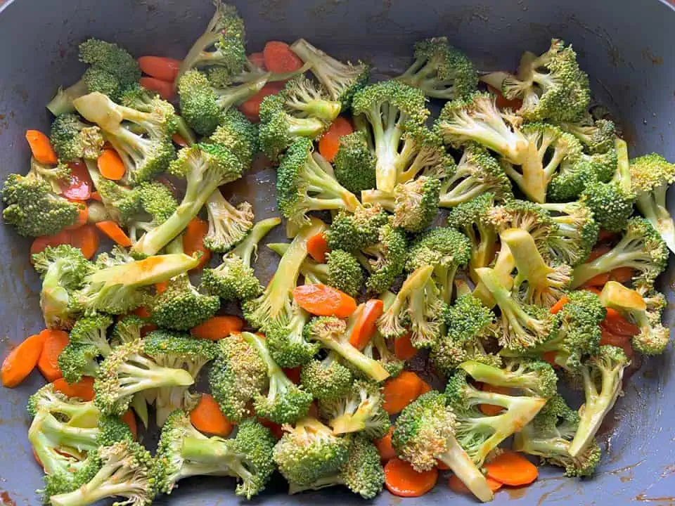 Broccoli and carrots sauteing in electric skillet.