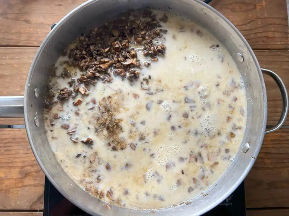 Cornstarch slurry with mushrooms cooking in a pan..