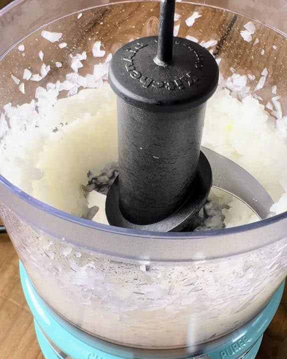 Onions chopped inside food processor.