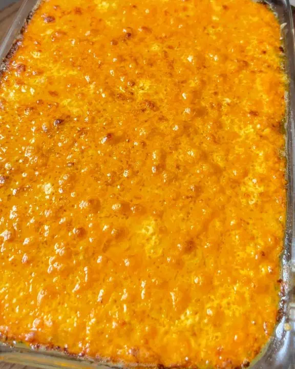 A casserole dish filled and topped with melted cheese, ready to be served and enjoyed.