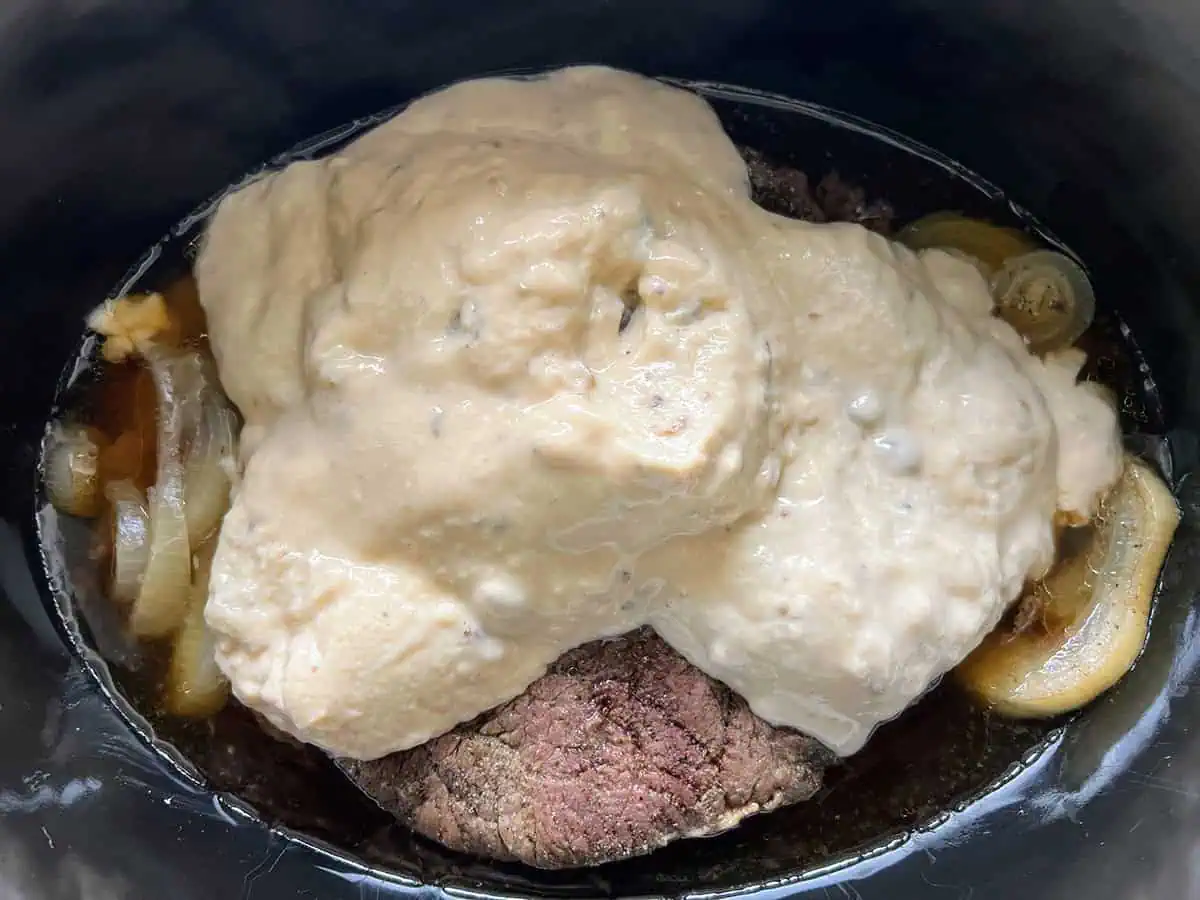 Cream of mushroom soup added over roast and onions