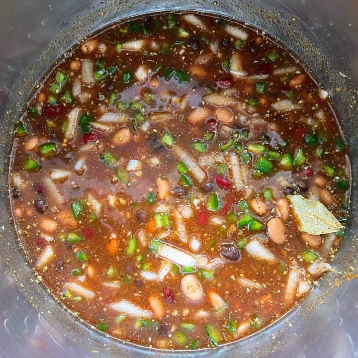 A Instant Pot filled with a colorful mix of beans and various fresh ingredients for chicken chili.