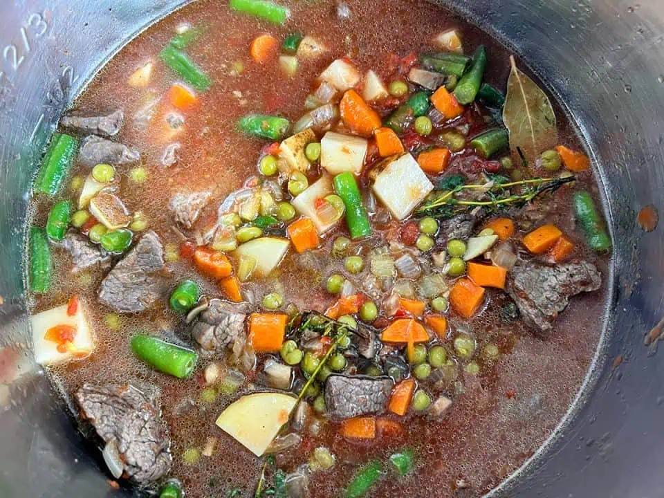 Uncooked vegetable beef soup in an Instant Pot.