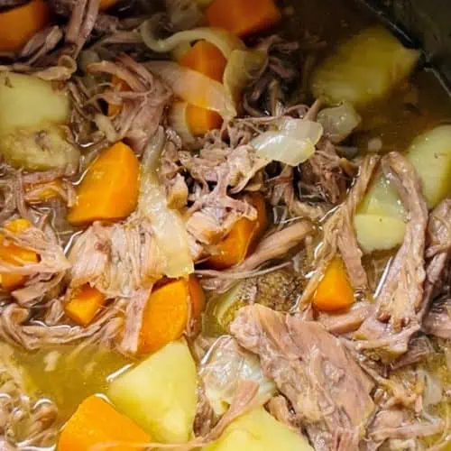 An Instant Pot filled pot roast, showing tender beef and chunks of potatoes and carrots.