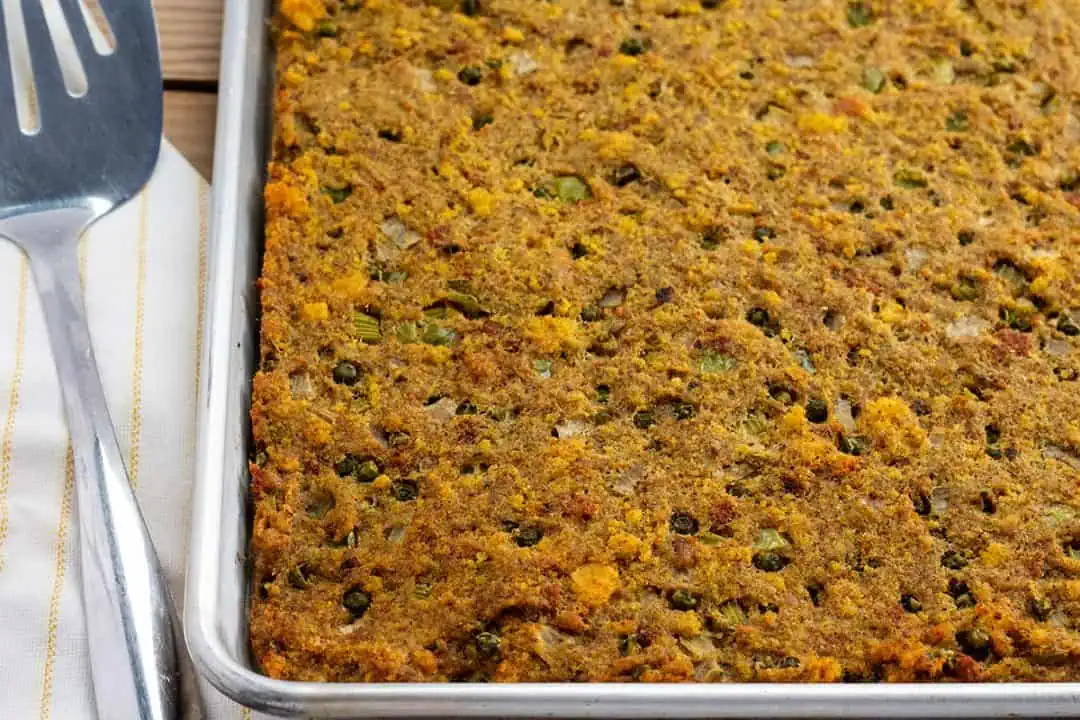 Southern cornbread dressing on a half-sheet pan.