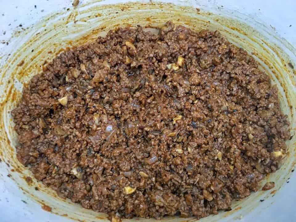 Cooked ground beef combined with tomato paste.