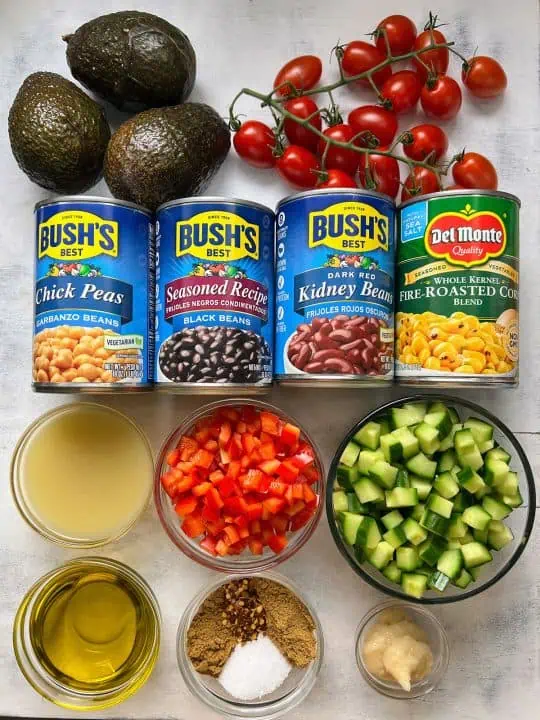 Ingredients for canned bean salad on marble white background.