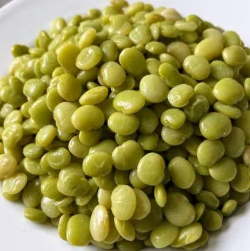 White bowl full of baby lima beans.