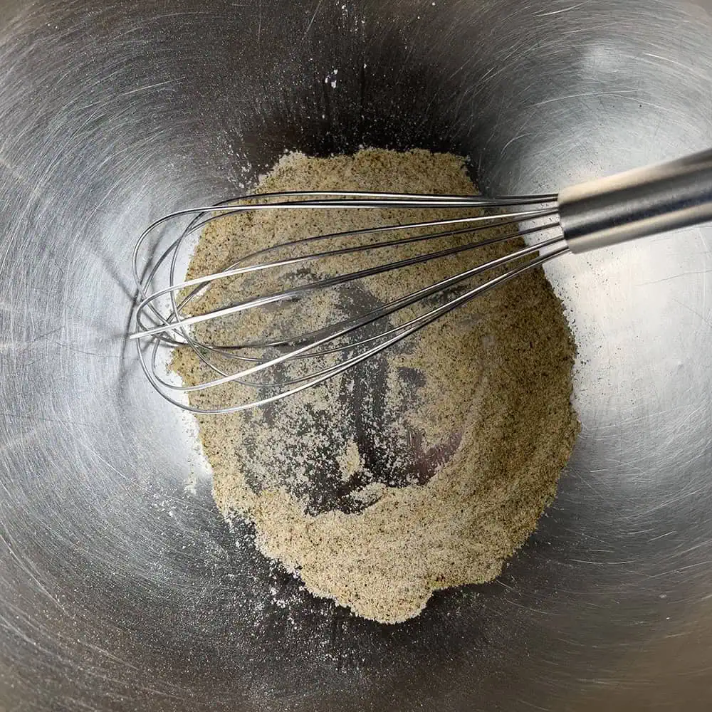 Whisk in a metal bowl with baking powder, garlic, onion, and pepper blended for the coating.