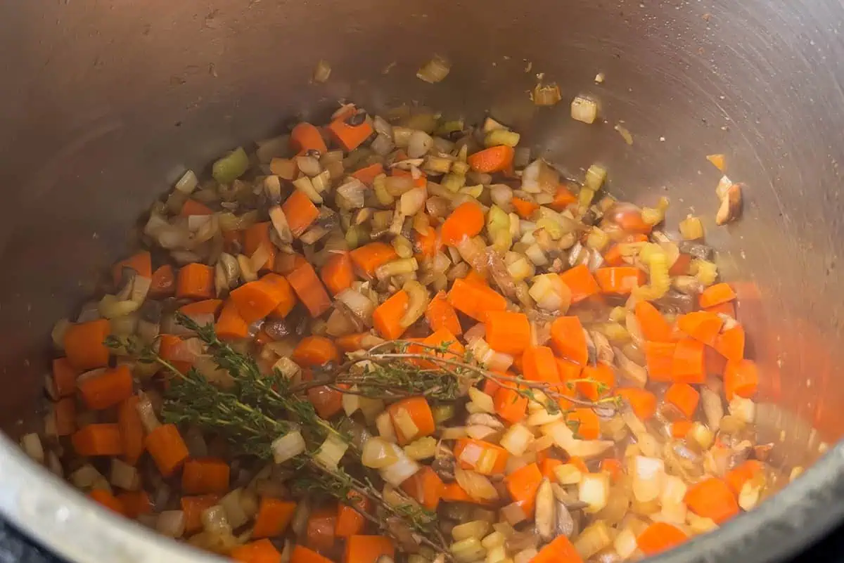Sautéing carrots, onions, celery, and thyme in Instant Pot