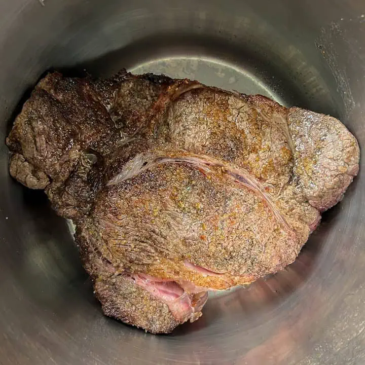 Chuck roast seared and browned inside the Instant Pot insert.