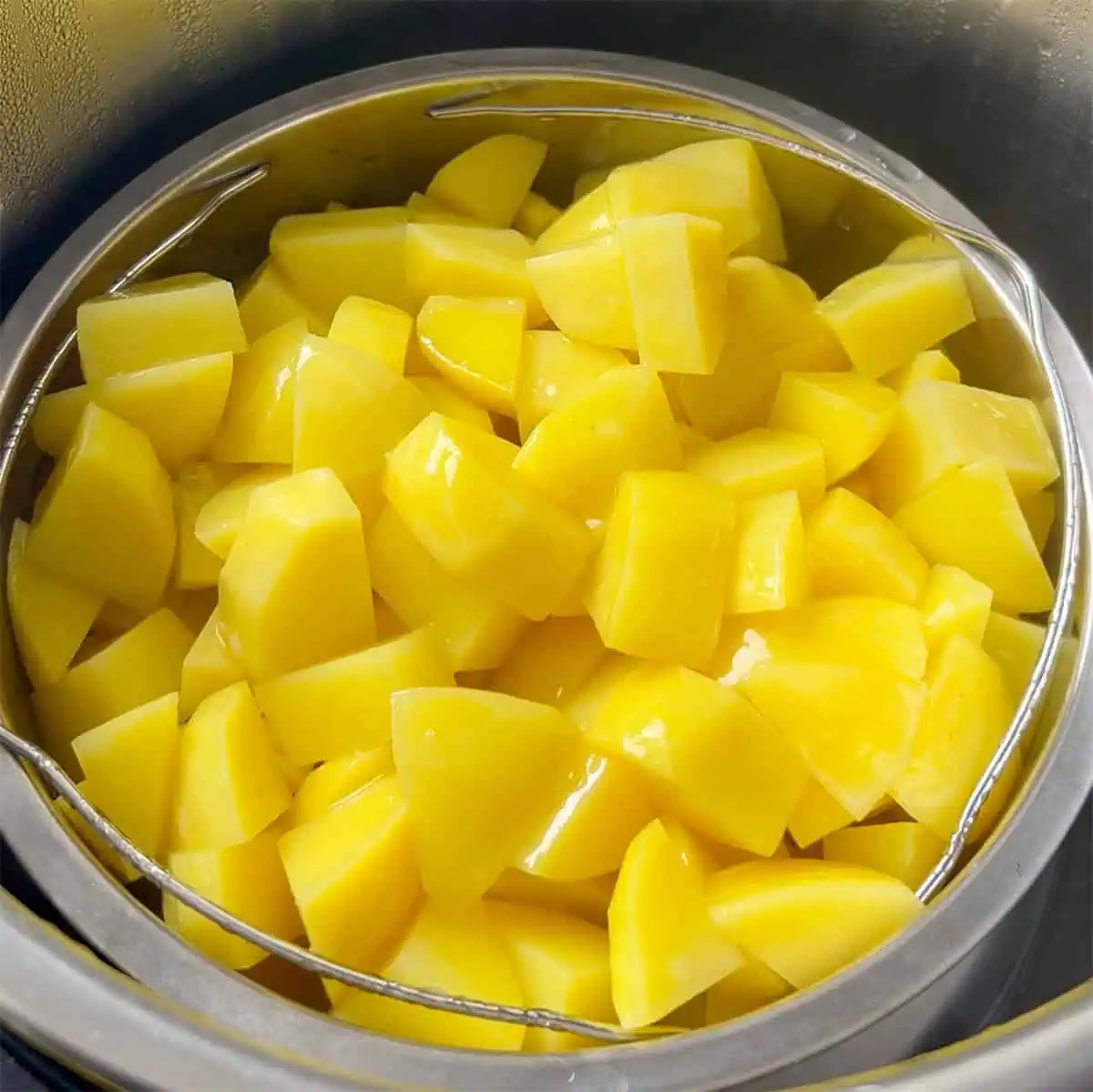 Potato chunks in a steamer basket inside an Instant Pot