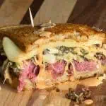 Leftover corned beef sandwich with Swiss, provolone, slaw, and Gary sauce on grilled rye bread