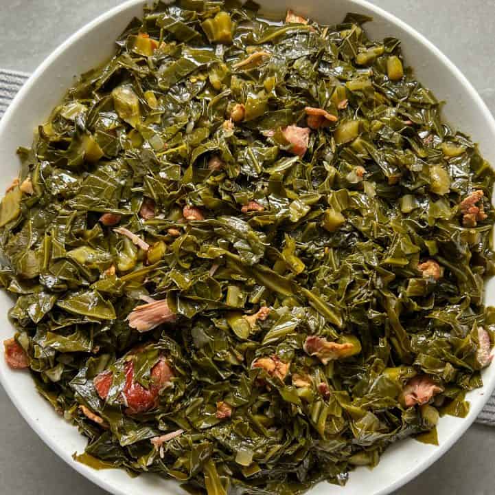 Instant Pot collard greens with smoked turkey and bacon served in a white bowl