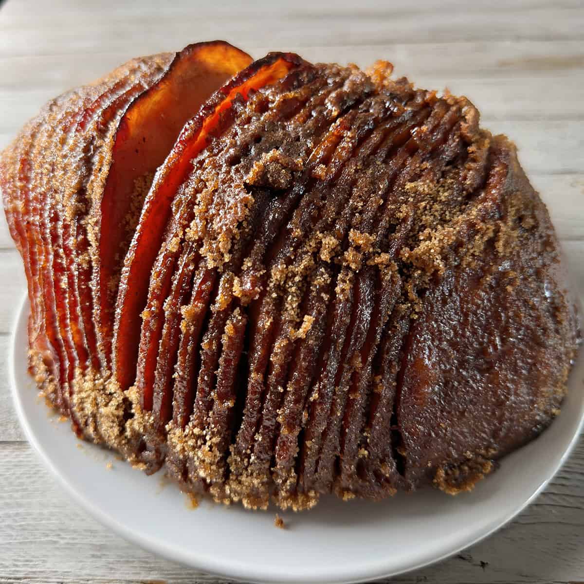 Finished Instant Pot spiral ham with a crisp brown sugar spice coating and caramelized edges.