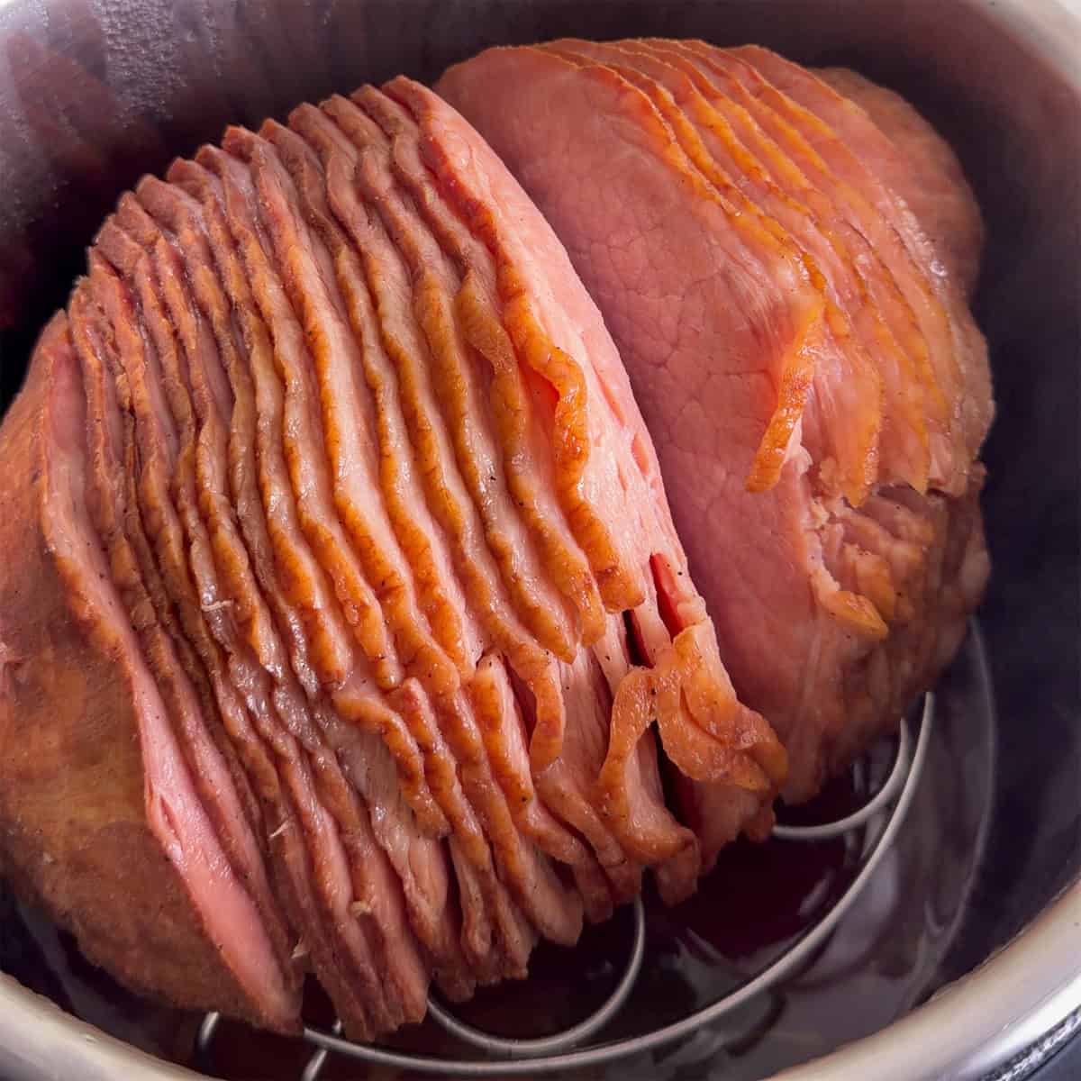 Spiral ham warmed in the Instant Pot on a trivet after cooking.