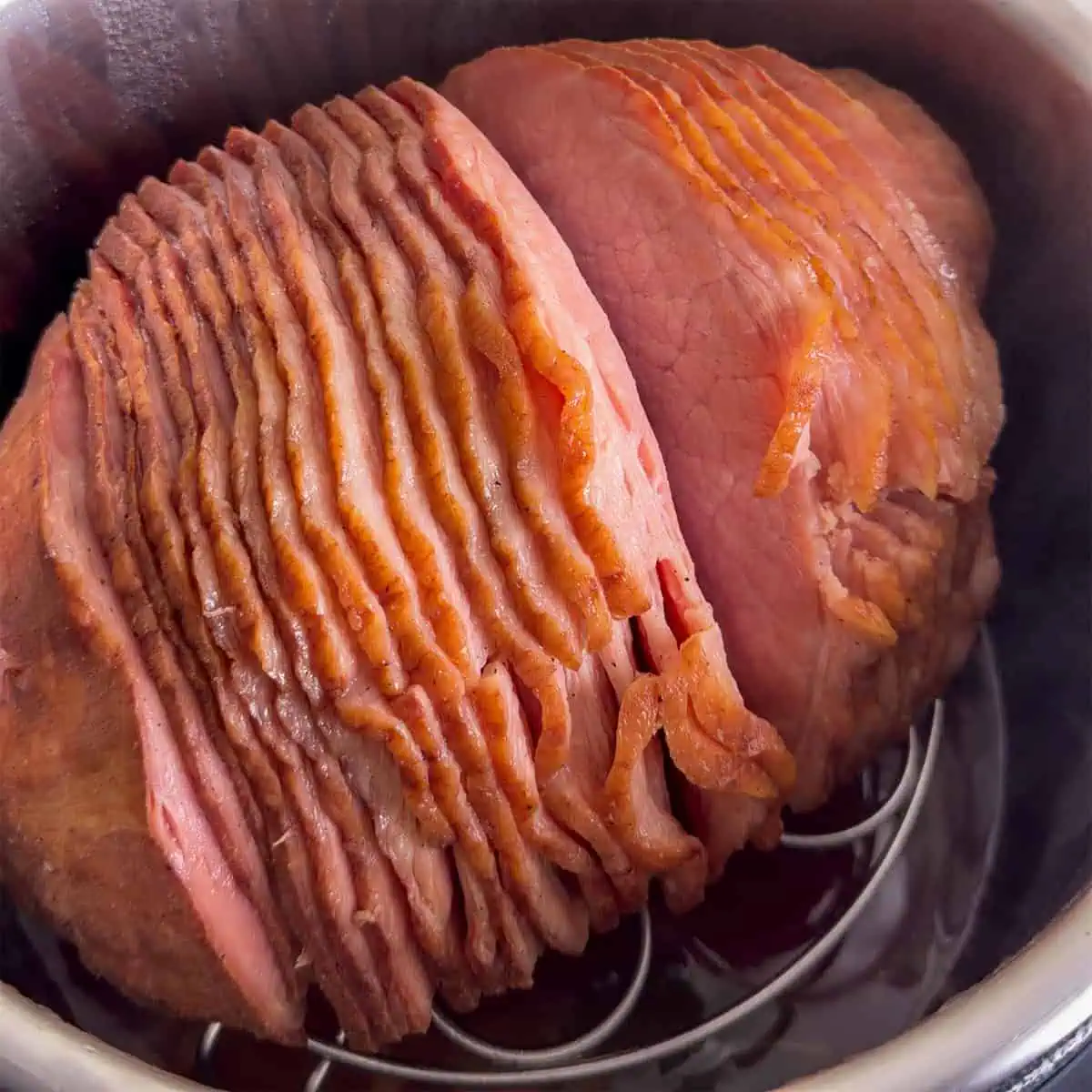 Spiral ham warmed in the Instant Pot on a trivet after cooking.