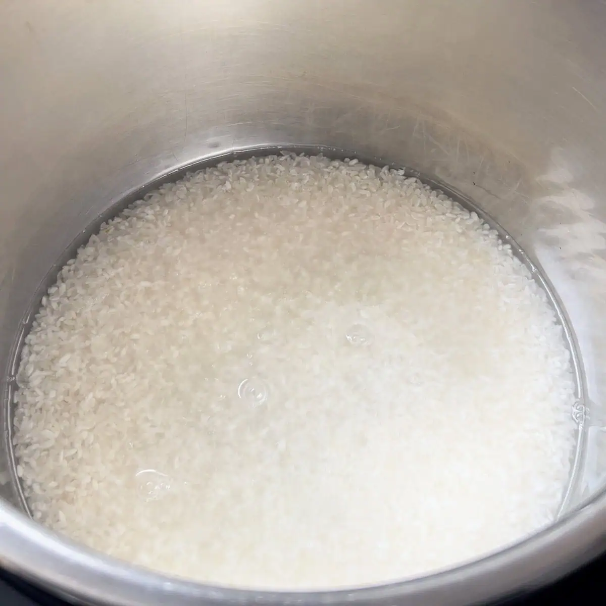 Short grain Japanese rice and water added to the Instant Pot before cooking